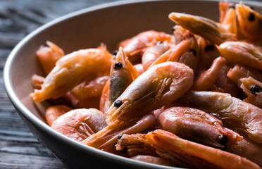 Closeup of raw orange shrimps in ceramic plate