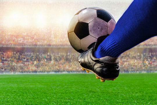 Fototapeta blue soccer player kicking ball action in the stadium
