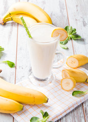 Fresh milk, strawberry, banana on wooden table, assorted protein cocktails with fresh fruits. Natural background.