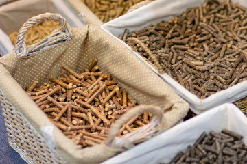 Wicker baskets with different kinds of pelleted compound feed on agricultural exhibition