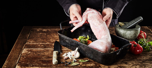 Chef preparing wild rabbit for a venison roast