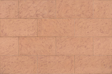seamless texture of red marble tiles on the wall