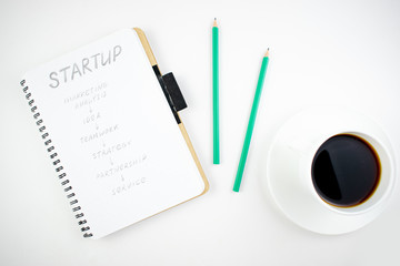 Minimalistic workplace concept, with a stationery, pen and business work records on a white background. Image of business plan, startup. Top view. Flat lay style.