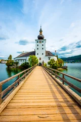 Fotobehang Blauwe hemel Amazing view of wooden bridge to the Schloss Ort castle and landscape around in Gmunden, Austria  © Ievgen Skrypko