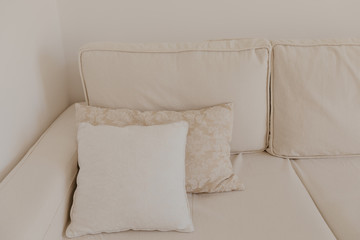 Fototapeta na wymiar beige sofa with pillows in living room
