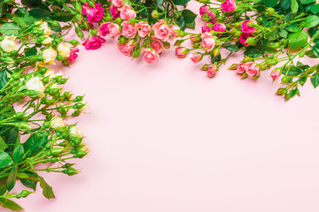 bouquet of small colored roses on a rose  background top view - Image