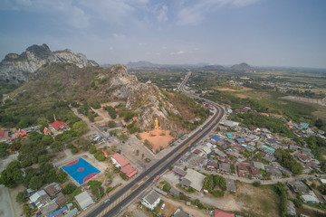 Aerial view above Khao Ngu Stone Park Rock Mountain, reservoir, high way and rice fields with cloudy sky background, Ratchaburi, Thailand.