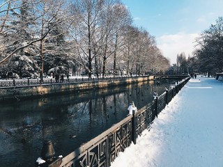 Snowy city embankment art sunny day