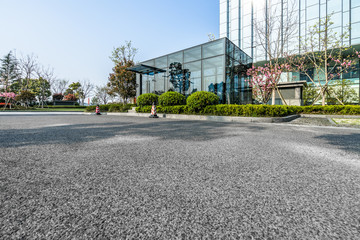 Fototapeta na wymiar empty asphalt road near glass office building.