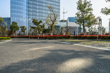 Fototapeta premium empty asphalt road near glass office building.