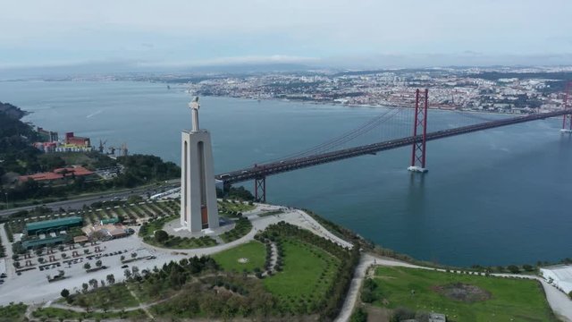 Aerial wide drone view of Lisbon bridge and Sanctuary of Christ the King - Portugal