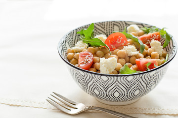 Delicious chickpeas salad on a plate, healthy food, close up