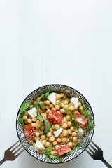 Healthy vegetarian salad, chickpea in a bowl on white background, copy space, top view