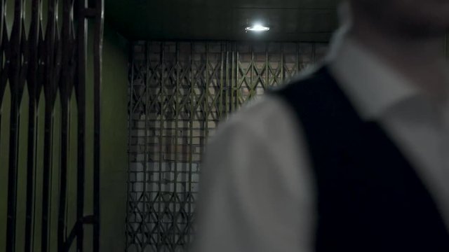 Portrait two gangsters men in formal suits and fedora hat opening a metal forged gates