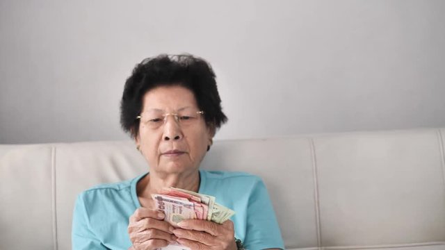 Senior woman receive subsistence allowance from government, lifestyle concept.