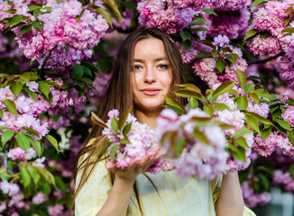 Fototapeta premium blossom smell, allergy. woman in spring flower bloom. natural summer beauty. skincare and spa. Natural cosmetics for skin. girl in cherry flower. Sakura tree blooming. Memorize this moment