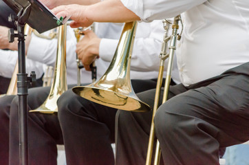 ands and trumpets of symphony orchestra musicians close up