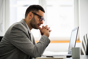 Young businessman is working in office.
