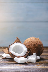 Open coconut with white pulp on wooden background. Organic healthy dietary vegan product widely used in cosmetics