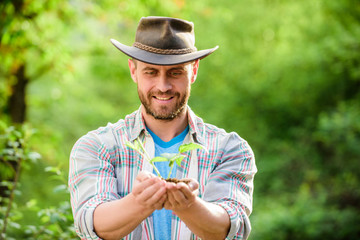 successful farmer hold plant in ground in hands. farming and agriculture cultivation. Gardening. Eco farm worker. Earth day. happy earth day. Eco living. muscular ranch man in cowboy hat care plants.