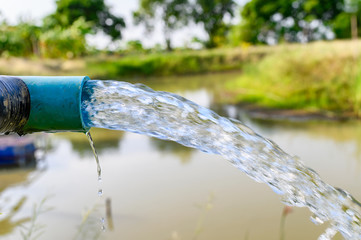 Agriculture blue pipe with groundwater gushing