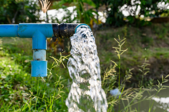 Agriculture blue pipe with groundwater gushing