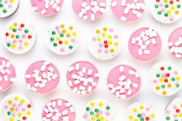 Colorful cupcakes on a white background.