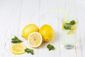 Ready fresh citrus mint drink and lemons