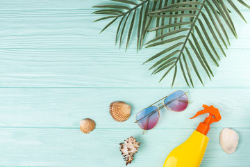Tropical leaves with beach accessories in composition