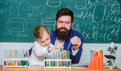 Fascinating chemistry lesson. Man bearded teacher and pupil with test tubes in classroom. Private lesson. School chemistry experiment. Explaining chemistry to kid. How to interest children study