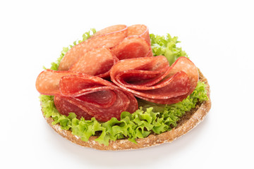 Sandwich with salami sausage on white background.