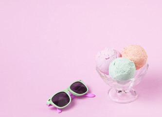 Ice cream balls on glass bowl near sunglasses