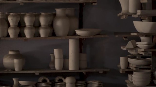 Panning Shot Of A Multan Potting Studio, Handmade Pottery Sitting On Shelves.