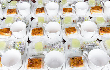 Set of cup and snack on dish for coffee break between meeting with light background,coffee concept.