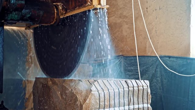 Marble being cooled with water. Marble cooled with water while being cut