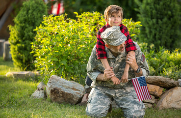 Happy reunion of soldier with family outdoors