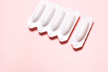 suppository on a pink background, for the treatment of hemorrhoids, vaginal  candidiasis