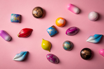 Chocolate bonbons set on pink background