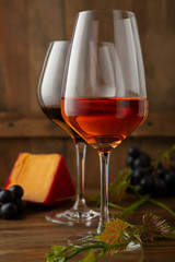 Two glasses of wine on wood