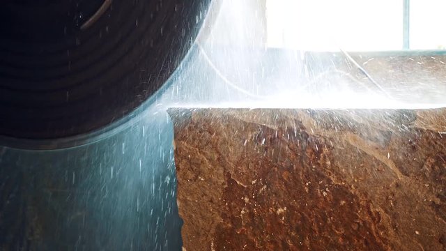 Machine cutting a marble block. Marble sawing machine in a factory from a quarry