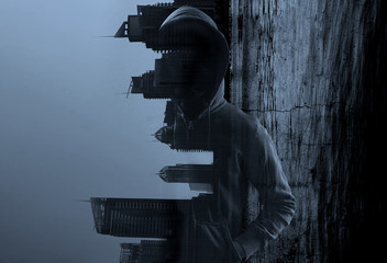 Suspicious man in hoody against city background