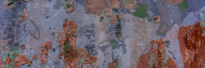 wall covered with old crumbling cement multi-colored plaster.