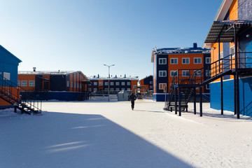 Hostel building. Sandwich panels painted in blue and orange. Port Sabetta, Yamal, Russia