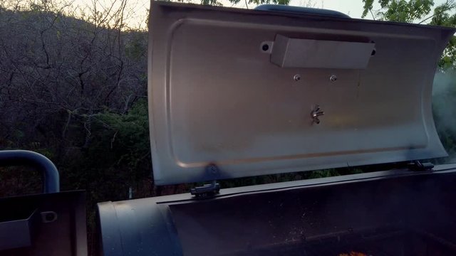 Smoke coming out of the BBQ pit. Imagine how delicous the foos will be. This summer we will for sure have Barbeque muliple times.