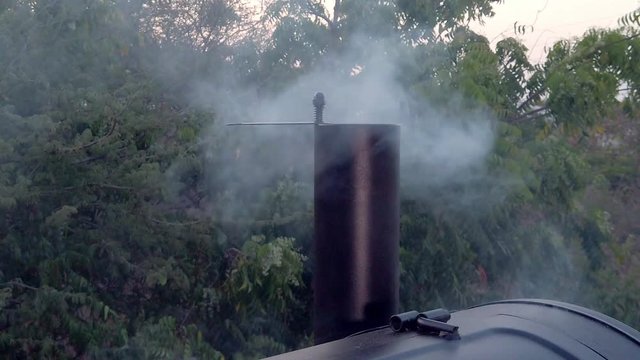 Smoke coming out of the BBQ pit. Imagine how delicous the foos will be. This summer we will for sure have Barbeque muliple times.