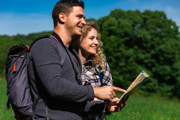 Portrait of young couple enjoying hiking together in nature.