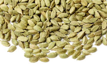 Green cardamom pods on white background