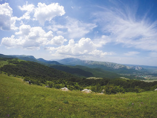 Fototapeta na wymiar Beautiful summer sunny mountain landscape with a clear blue sky with clouds background. Crimean mountains