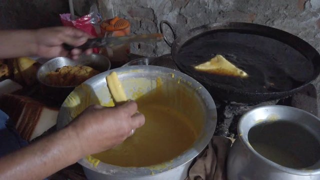 Close-up of popular snack of bread pakora stuffed with spiced mashed potatoes. a favorite breakfast and tea or chai time snack in Indian subcontinent. slow motion Handheld stabilized gimbal 4k