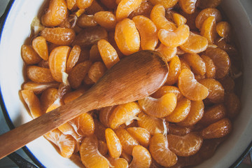 Tangerine slices  bowl  in a jam process